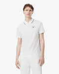 เสื้อโปโลผู้ชาย ULTRA DRY BADGE ACCENT TENNIS HERITAGE POLO SHIRT (White / Navy Blue • EV0)